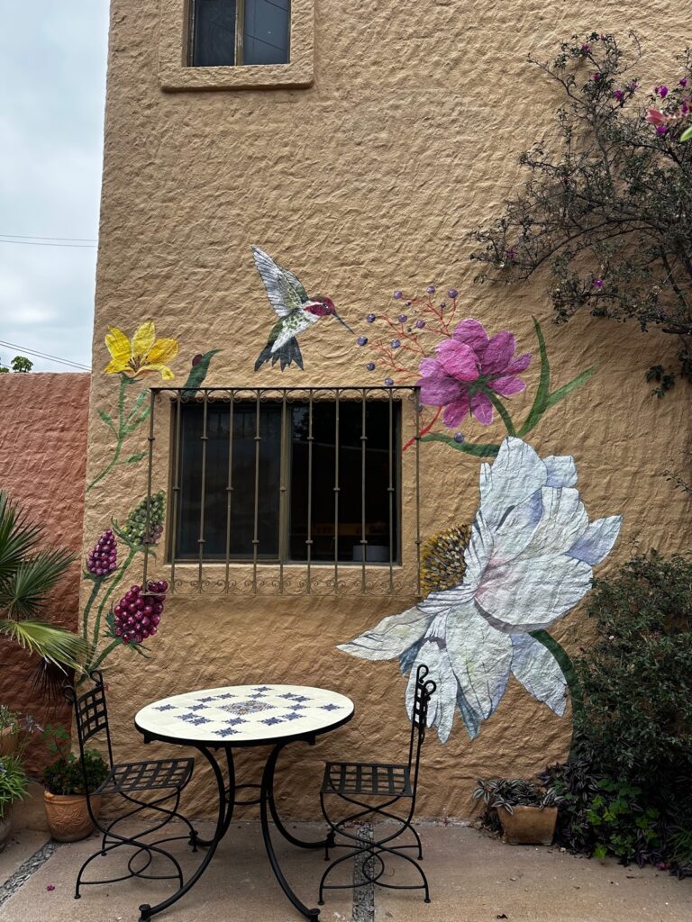Hummingbird and floral mural on the exterior patio wall